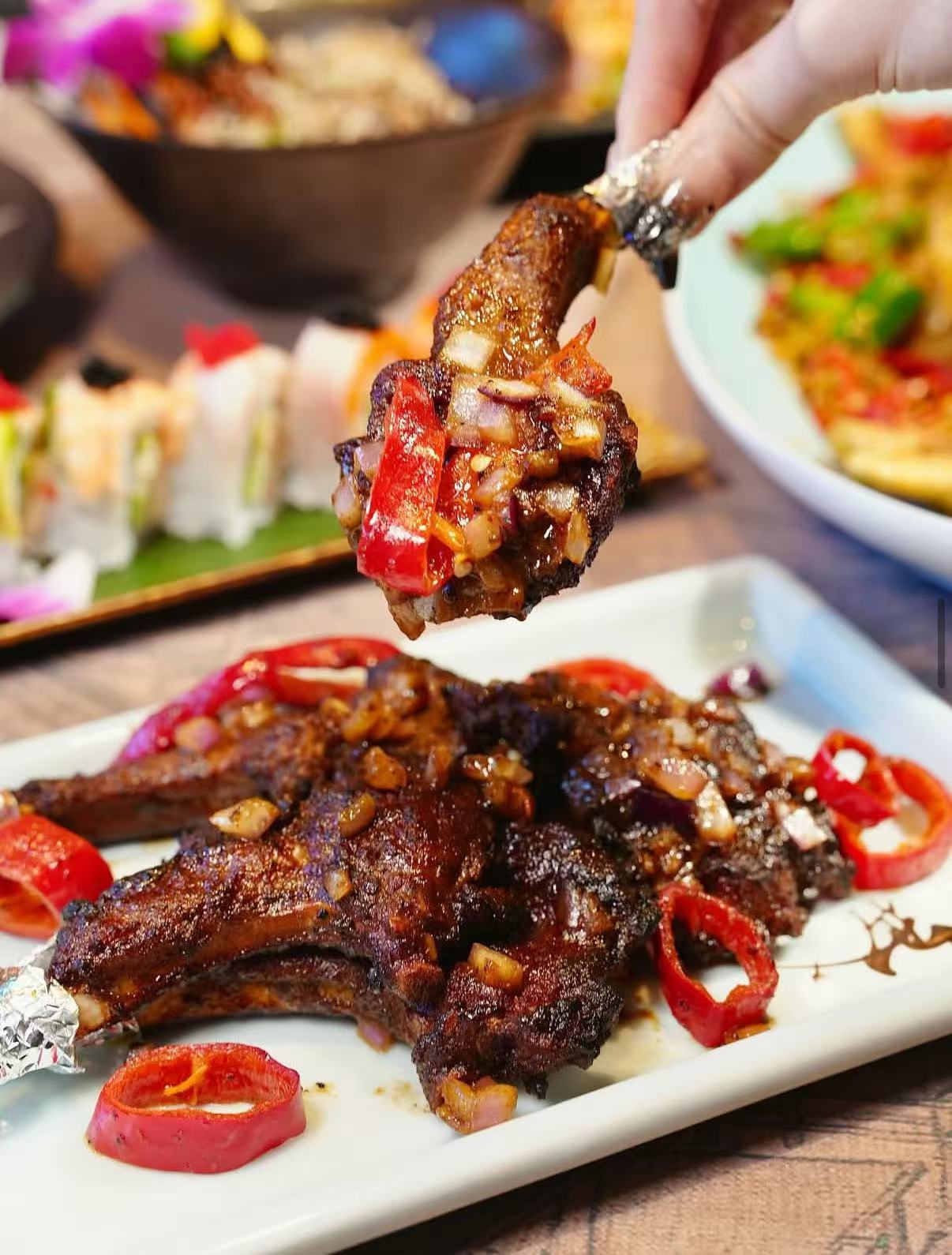 Close-up of glazed grilled meat with red peppers